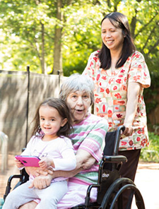Resident smiling with Ellen and McKenna